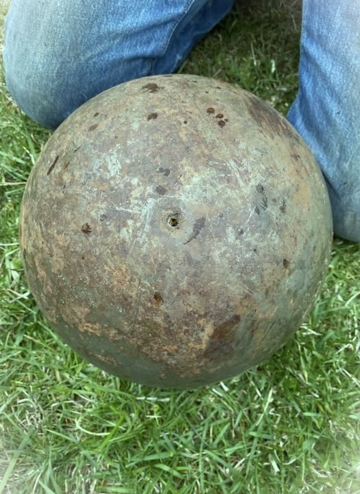 Found an enormous 150-lb steel ball in a creek close to my place. It has tiny drilled holes and leaked black liquid when handled. Does anyone know what it might be? Check the comments for more…