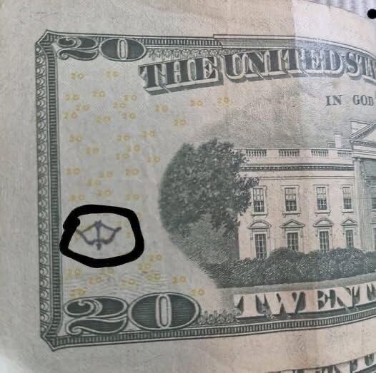 Why does my $20 bill have a bow and arrow symbol on it? (Check In First comment👇)